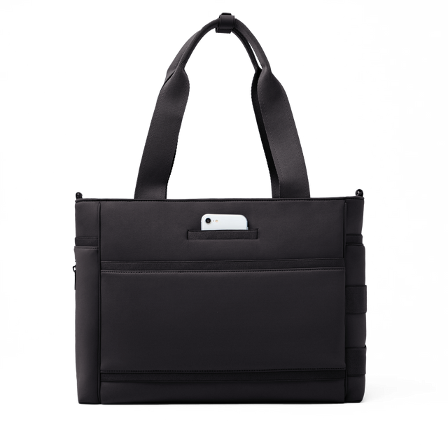 Dagne Dover large Wade Diaper Tote in black seen from the back with a phone in the exterior phone pocket.