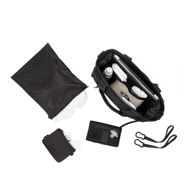 hover - Dagne Dover large Wade Diaper Tote in black seen from above, alongside the changing mat, neoprene pouch, and water resistant zipper bag.